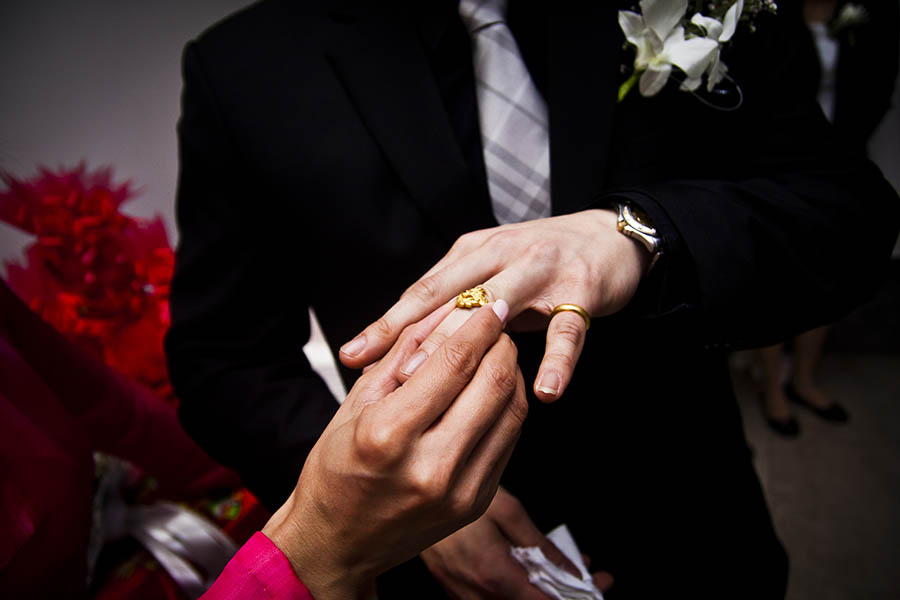 Danang City Wedding - bride putting ring on groom's finger