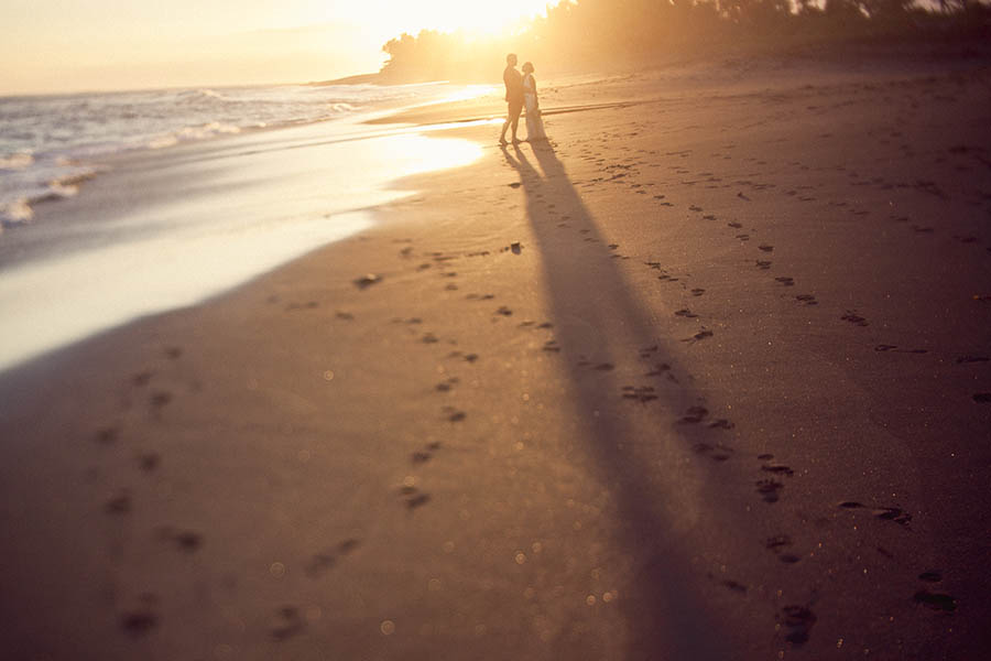 Bali Indonesia Wedding Photographer - Long shadows of newlyweds on beach