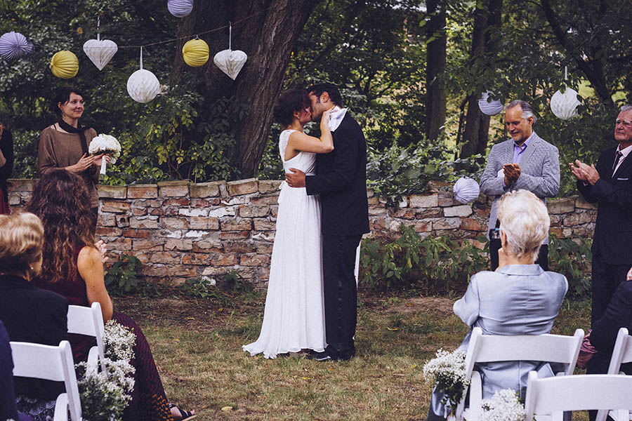 Villa Biesenthal wedding - Bride and groom kiss during open air ceremony