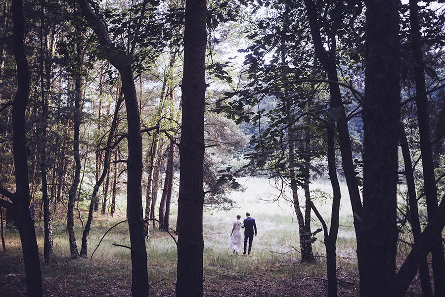 Bernau wedding - newlywed couple walking through forest